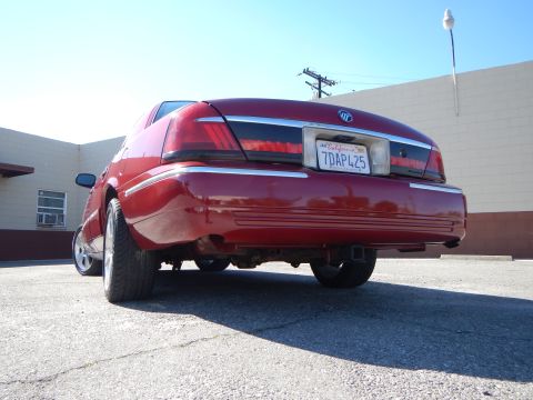 2002 Mercury Grand Marquis - Rear view of a red 2002 Mercury Grand Marquis sedan with a California license plate.