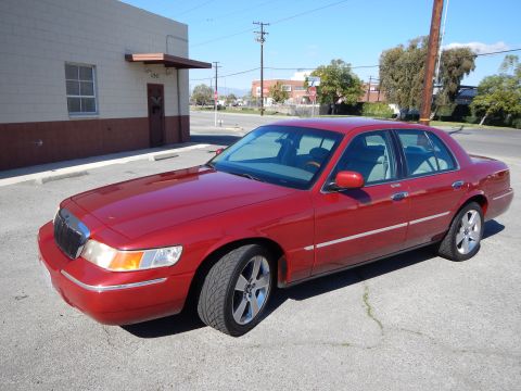 2002 Mercury Grand Marquis - Red 2002 Mercury Grand Marquis parked on a sunny day.