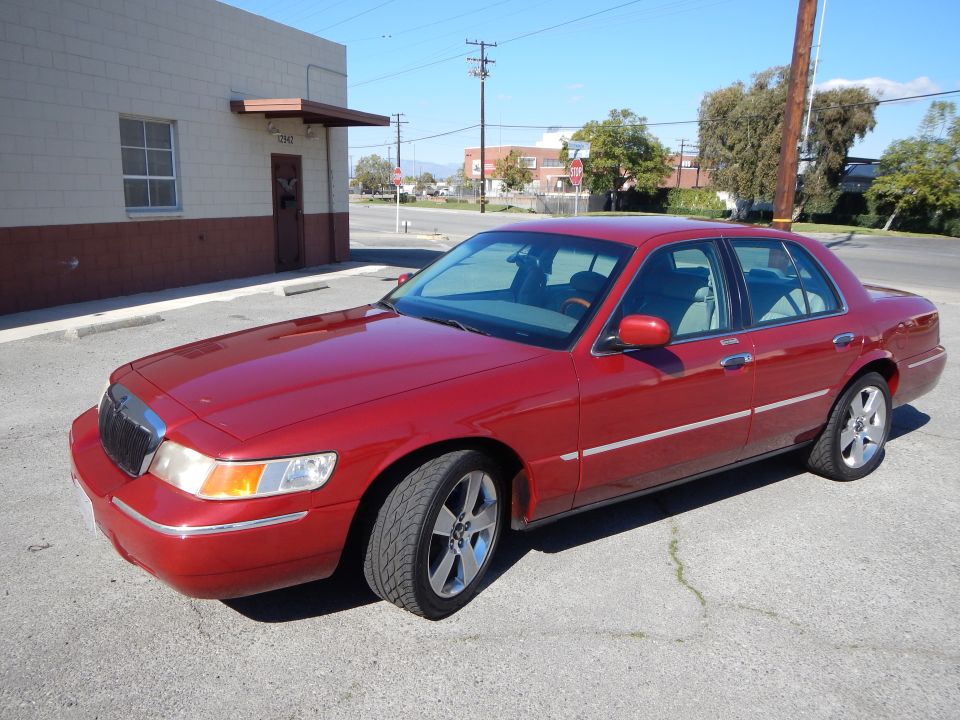 2002 Mercury Grand Marquis, red, parked outside a building