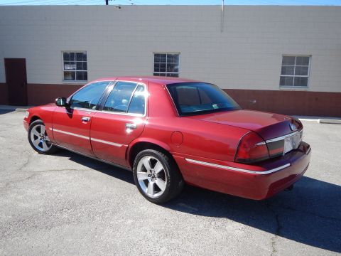 2002 Mercury Grand Marquis - This red 2002 Mercury Grand Marquis sedan is shown from the rear three-quarter angle.