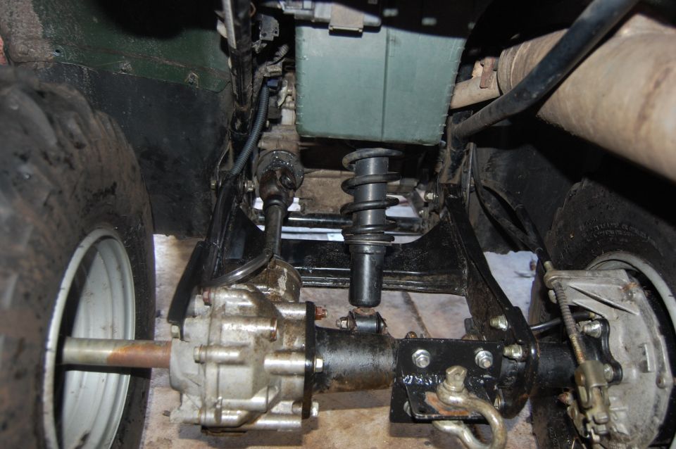 ATV rear axle, driveshaft, and suspension components visible