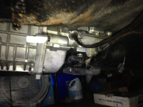 1981 Ford LTD - Trans bolted down with the spacer installed. The top of the trans just touched the floor pan. I later pulled the trans and hammered a coupl…