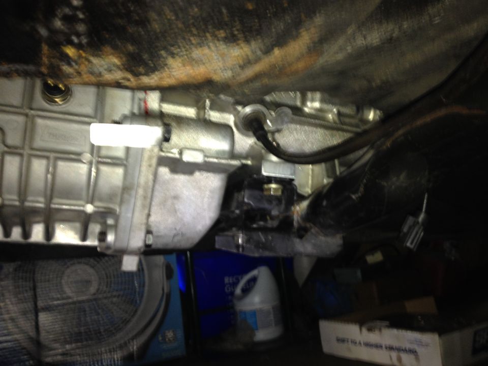 Trans bolted down with the spacer installed. The top of the trans just touched the floor pan. I later pulled the trans and hammered a couple divots for clearance.
