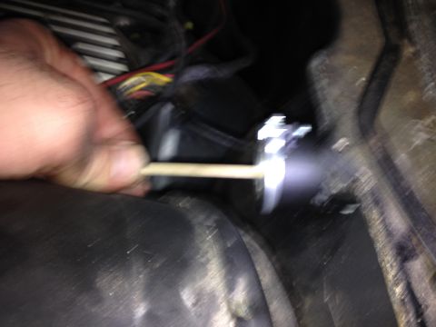 1981 Ford LTD - Blurry but the wire goes straight through the center of the firewall adjuster and to the top of the adjuster.