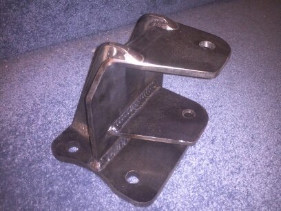 1995 Ford Bronco - A metal bracket with visible welds is shown against a blue background.