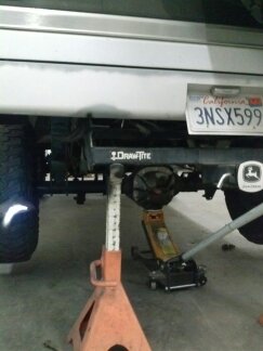 1995 Ford Bronco - Vehicle is supported by jack stands and a hydraulic jack under the rear axle.