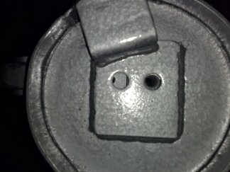1995 Ford Bronco - Close-up of a metal component, possibly a bracket or adapter, with visible text from SuperMotors.net.
