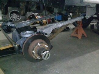 1995 Ford Bronco - Close-up of a vehicle's front axle and suspension components, with a SuperMotors watermark visible.