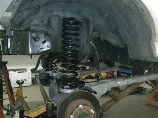 1995 Ford Bronco - Rear suspension parts of a Ford Bronco, including a coil spring and shock absorber assembly.