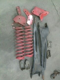 1995 Ford Bronco - Various suspension components laid out on a concrete surface.