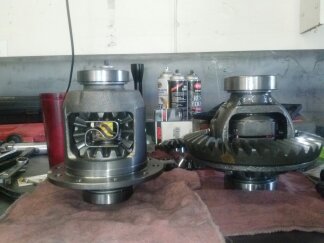 1995 Ford Bronco - Two differential assemblies are displayed on a workbench, likely for comparison or installation.