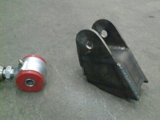 1995 Ford Bronco - A close-up view of a suspension component and a metal bracket.