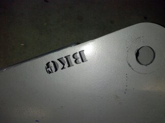1995 Ford Bronco - A close-up of a metal component with visible text and a website logo.
