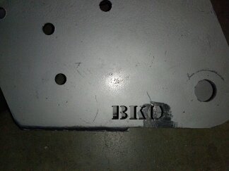 1995 Ford Bronco - Close-up of a gray metal part stamped with the letters BKD.