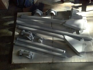 1995 Ford Bronco - Painted suspension parts are arranged on a flat surface, with a website logo in the corner.
