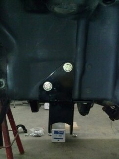 1995 Ford Bronco - Close-up view of a black metal suspension bracket and hardware.