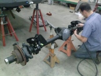 1995 Ford Bronco - Close-up of a vehicle axle assembly being serviced in a workshop.