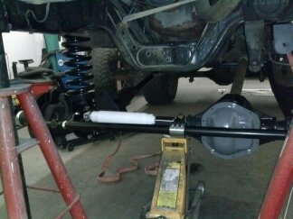 1995 Ford Bronco - Close-up view of a vehicle's undercarriage, showing suspension and steering systems.