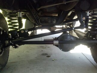 1995 Ford Bronco - Vehicle undercarriage showing suspension and steering components, likely a 4x4.