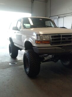 1995 Ford Bronco - This lifted 1995 Ford Bronco features oversized tires and a modified suspension system, giving it an aggressive stance.