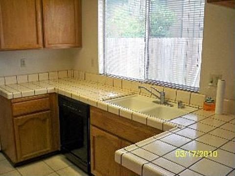 1989 Ford Bronco - A view of a kitchen counter area, including a sink, faucet, and cabinets, with a date stamp visible on the counter.