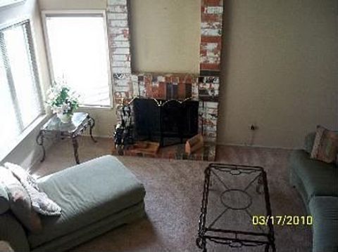 1989 Ford Bronco - Interior view of a living room a brick fireplace and various furniture pieces, with a date stamp of 03/17/2010.
