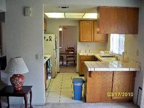 1989 Ford Bronco - Interior view of a kitchen with wooden cabinets and tiled countertops, dated 03/17/2010.