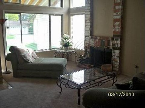 1989 Ford Bronco - Interior view of a living room a fireplace and furniture, a chaise lounge, and a coffee table.