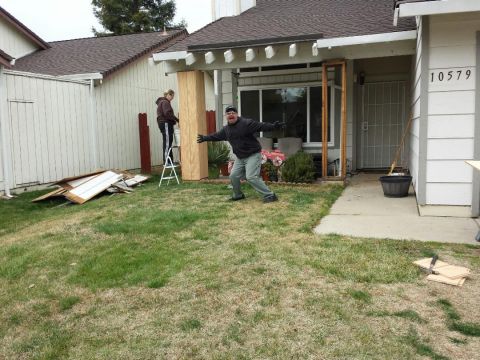 1989 Ford Bronco - Two people are working on home renovations, with one man enthusiastically posing for the camera.