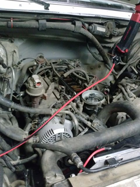 1995 Ford Bronco - Close-up view of a vehicle's engine bay, showing various components and wiring.