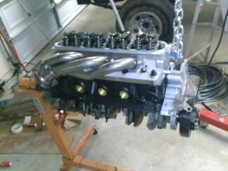 1995 Ford Bronco - Engine assembly on an engine stand, with a SuperMotors logo in the lower right corner.