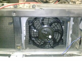 1995 Ford Bronco - Close-up view of an electric fan installed in front of a vehicle's radiator.