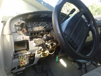 1995 Ford Bronco - The interior of a vehicle shows a disassembled dashboard with visible wiring and gauges.