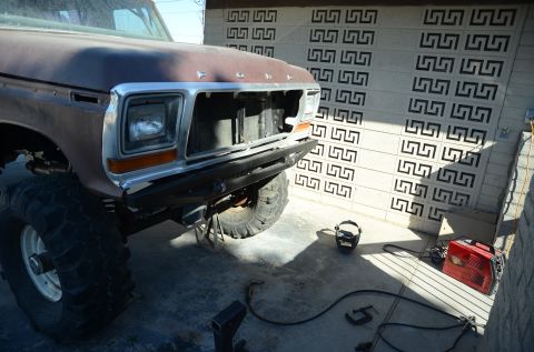 1979 Ford Bronco - This lifted 1978 Ford Bronco shows its front end with a missing grille and large off-road tires.