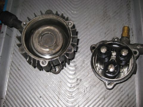 2006 Honda RANCHER - Disassembled pump components are laid out on a textured surface, revealing internal mechanisms.