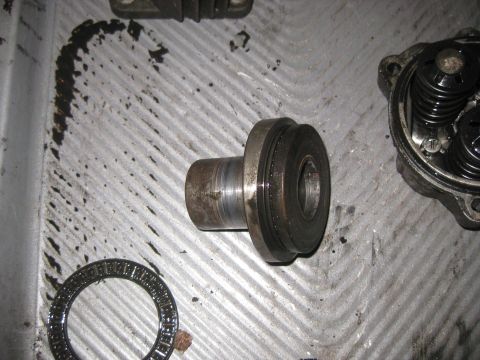 2006 Honda RANCHER - Disassembled engine components are laid out on a textured metal surface.