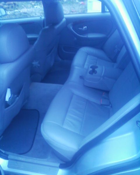 1999 Ford Fairlane - The interior of a car is shown, focusing on the rear seats and door panel.