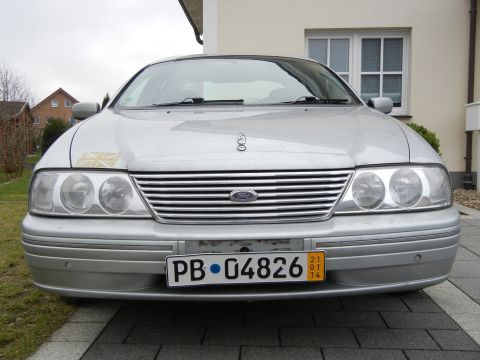 1999 Ford Fairlane - Front view of a silver sedan, a prominent chrome grille and a license plate.