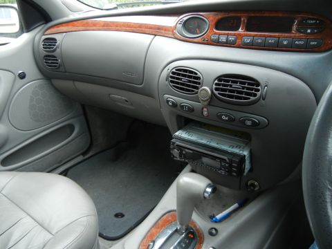1999 Ford Fairlane - Interior view of a 1999 Ford Fairlane, highlighting the dashboard and center console features.