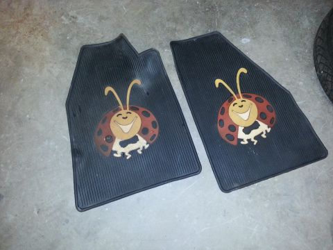 2002 Volkswagen Jetta - Pair of floor mats a cartoon ladybug design, likely for a car's interior.