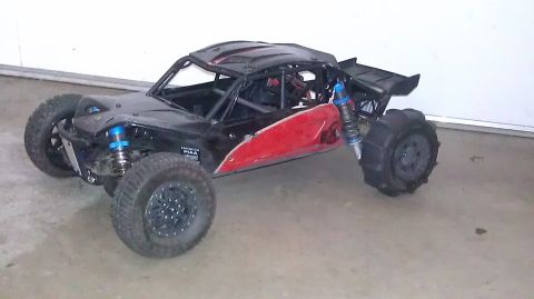 1996 Ford Bronco - A black and red remote control buggy sits on a concrete surface, ready for off-road action.