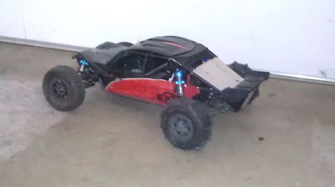 1996 Ford Bronco - This remote control buggy features a black body with red side panels and exposed suspension components.