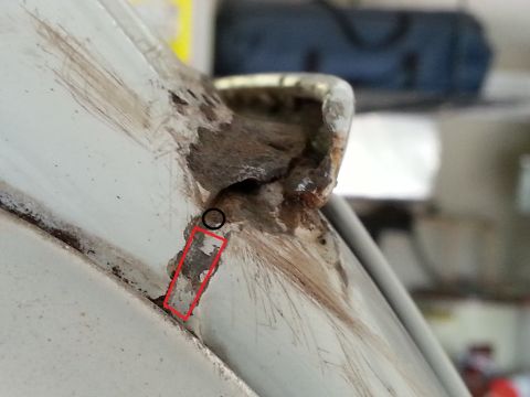 1992 Ford Bronco - Detail of rust damage on a vehicle's drip rail, marked for repair.