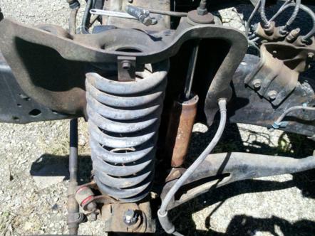 1982 Ford Bronco - This image shows the front suspension system of a vehicle, a coil spring and shock absorber.