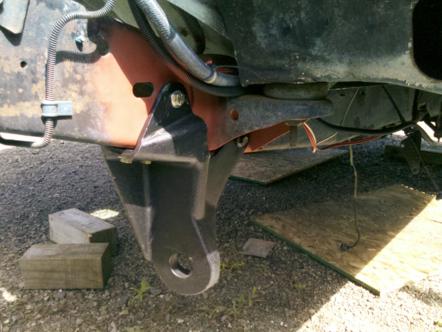 1982 Ford Bronco - Close-up view of vehicle frame and suspension components, with a tow hitch bracket visible.