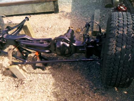 1982 Ford Bronco - Front axle and suspension components are shown supported by jack stands.