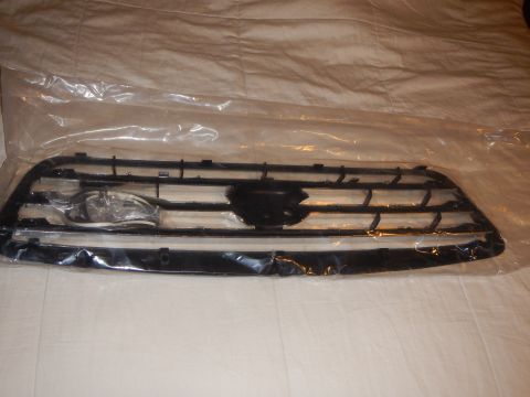 2003 Ford Crown Victoria - Rear side of a black plastic front grille showing mounting clips and a central emblem cutout, on a white sheet.