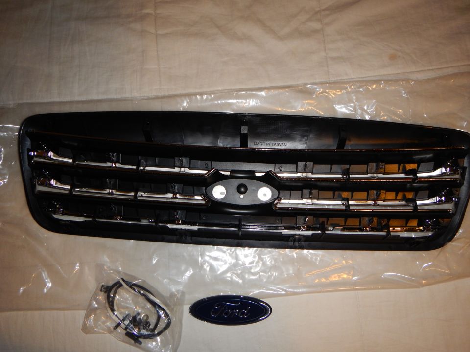 Rear of grille marked Made in Taiwan with hardware bag and blue Ford oval emblem