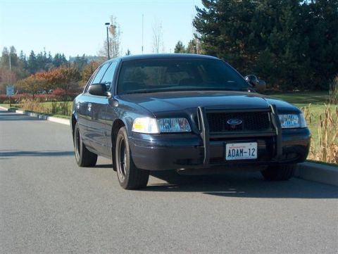 2001 Ford Crown Victoria - This 2001 Ford Crown Victoria police car is seen from the front, a push bar and a Washington license plate.