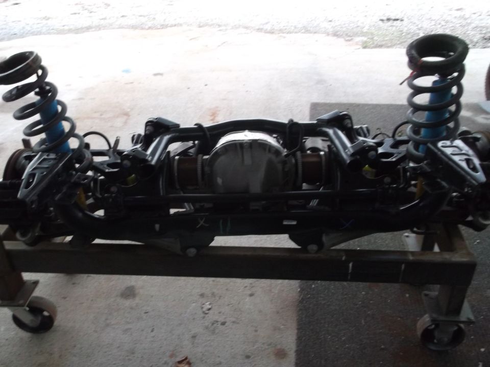 Rear axle assembly with coil springs and shocks